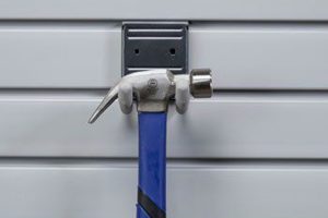 Hammer held onto wall by hooks