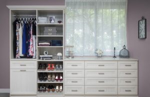 White closet organizer system next to window