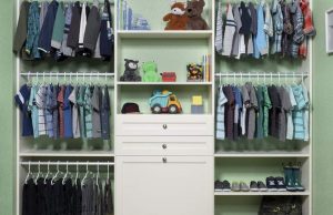 White closet organizer system with kids' clothes, shoes, and toys