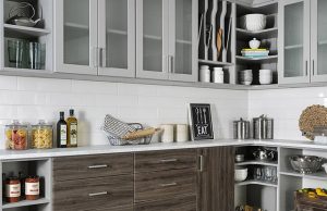 White cabinets and gray wooden drawers in kitchen with white countertop