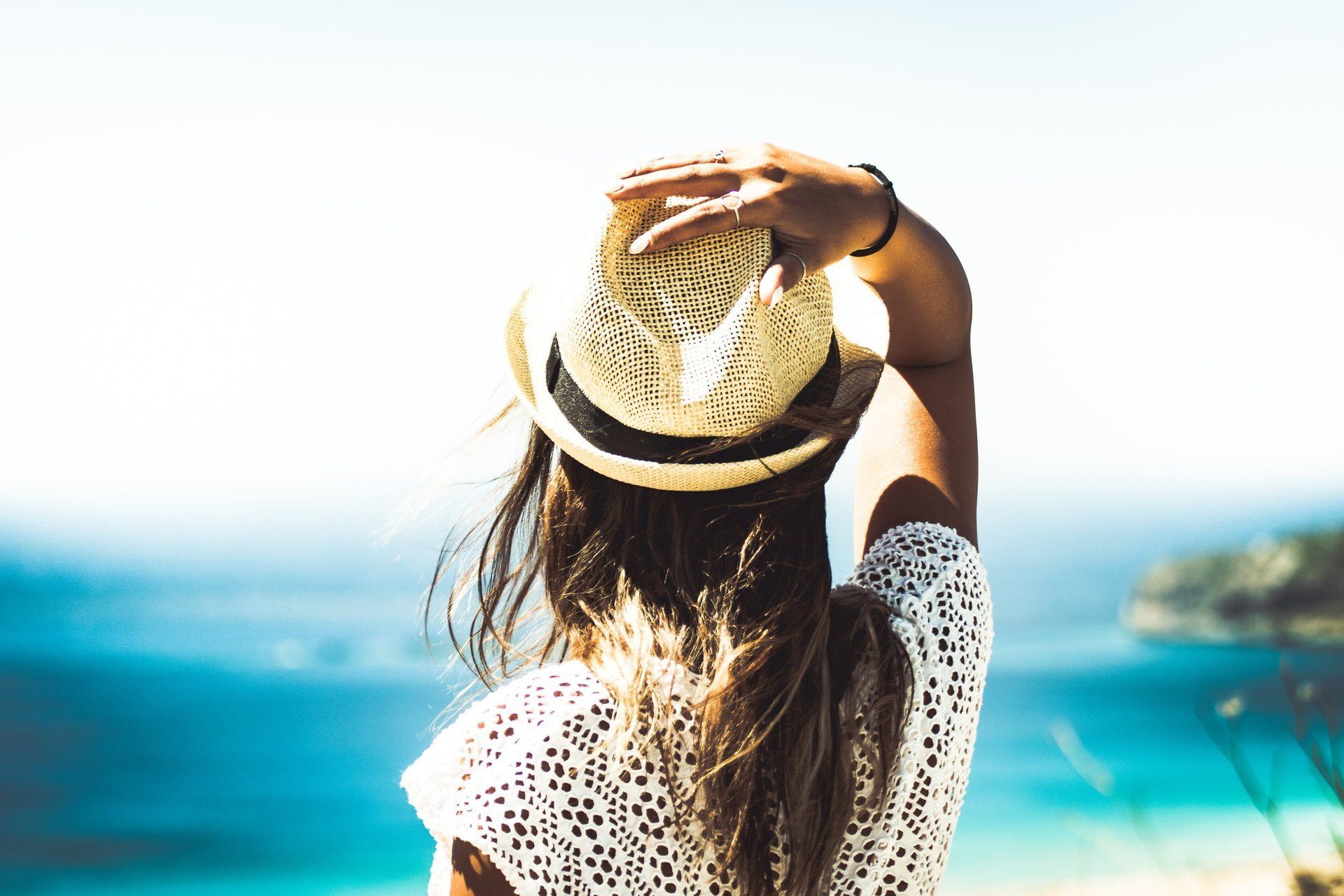 Woman in a hat at the beach