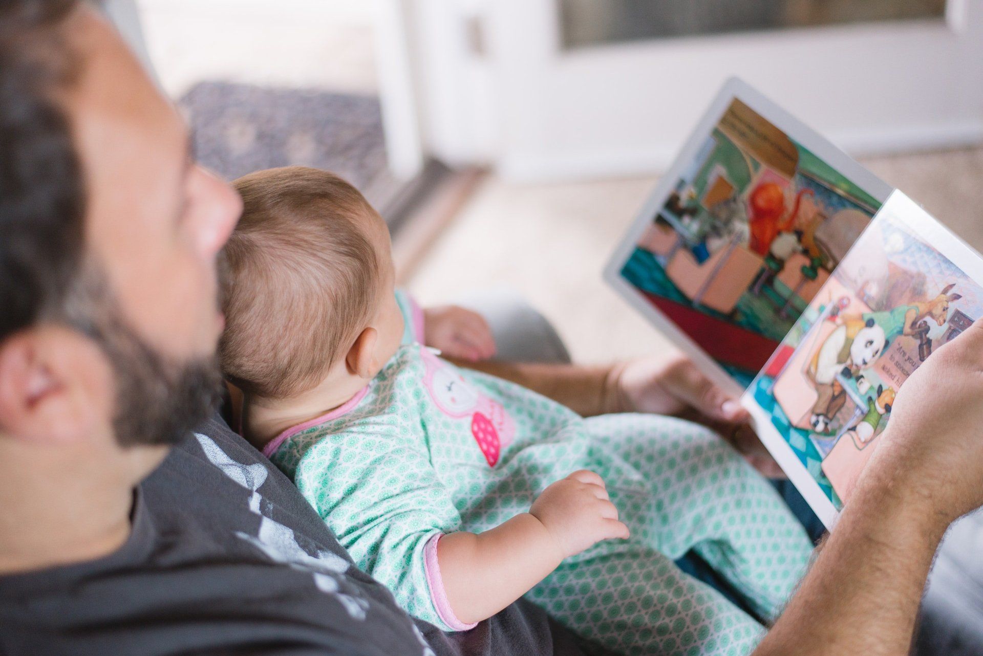 Father reading to his baby