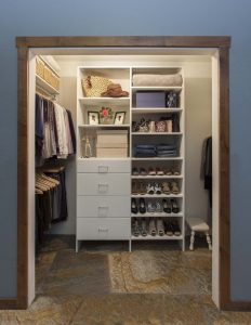 Illuminated reach-in closet organizer system with clothes and shoes
