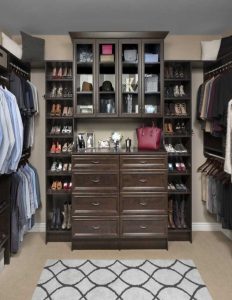 Walk-in closet organization system made of dark wood